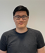 male with black hair wearing black t shirt and glasses
